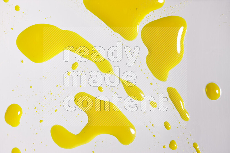 Close-ups of abstract yellow paint droplets on white background
