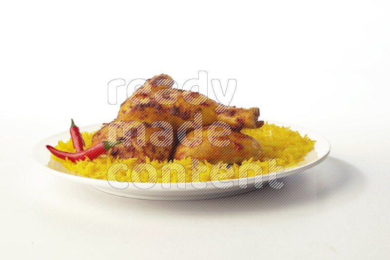 yellow basmati Rice with kabsa chicken pieces on a white rounded plate direct on white background