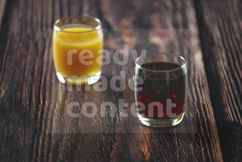 Cold drinks in a glass cup such as water, tamarind, qamar eldin, sobia, milk and hibiscus on wooden background