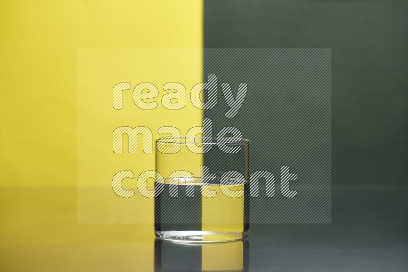The image features a clear glassware filled with water, set against yellow and dark green background