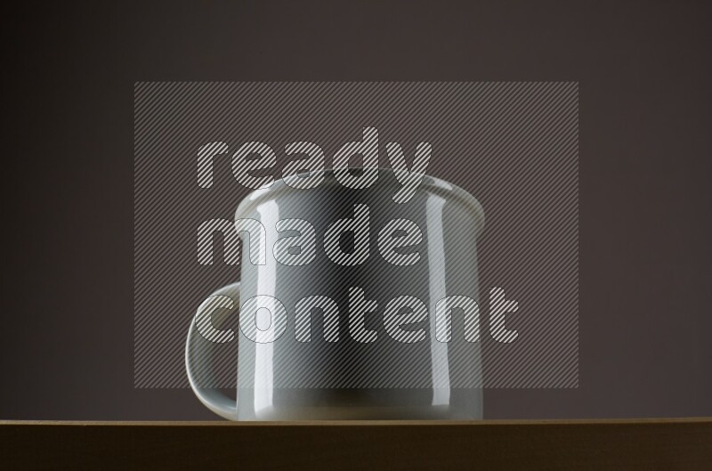 Low angle shot of a grey cup on grey background