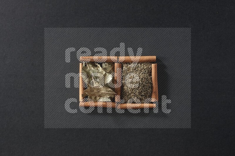 2 squares of cinnamon sticks full of cumin and bay laurel leaves on black flooring