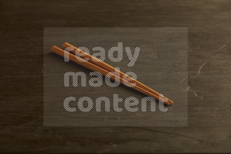 wooden chopsticks on black slate background