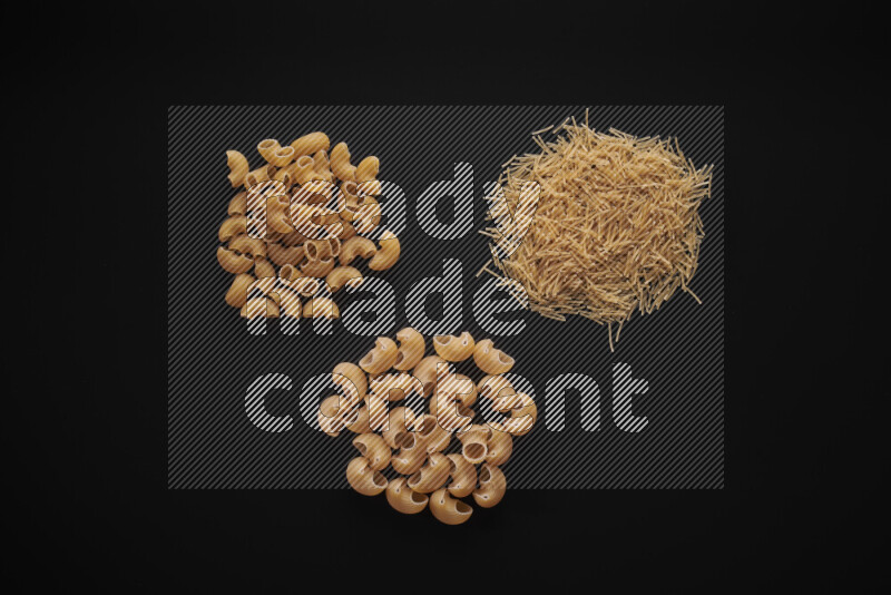 Different pasta types in bunches on black background