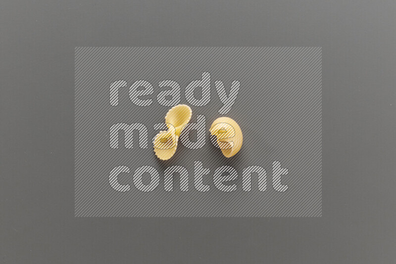 Fiocchi pasta with other types of pasta on grey background