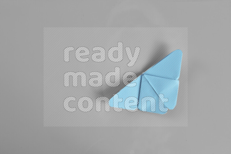 Origami butterfly on grey background