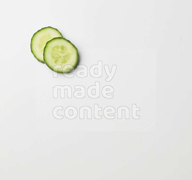 two cucumber slices on white background