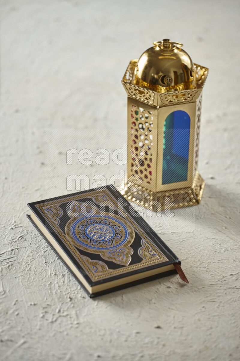 A golden lantern with different drinks, dates, nuts, prayer beads and quran on textured white background