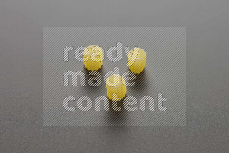 Small rings pasta on grey background