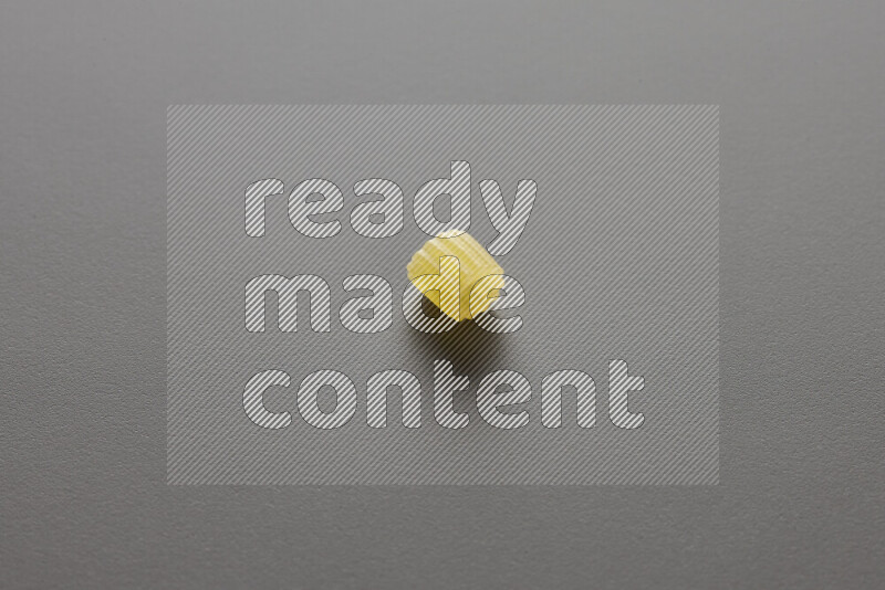 Small rings pasta on grey background