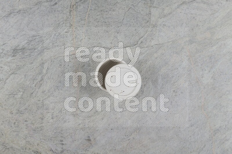 A multicolored pottery Cup on grey marble background