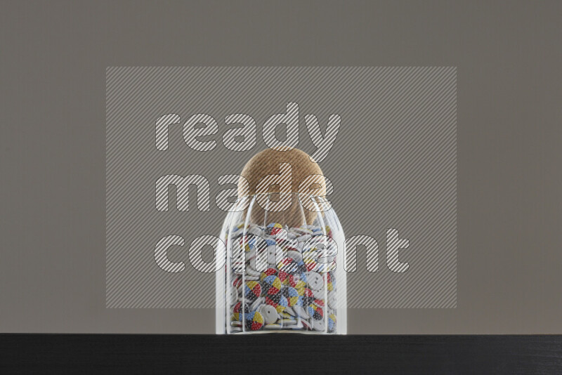 Buttons in a glass jar on black background