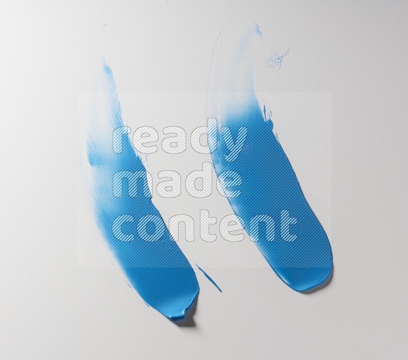 Blue curved painting knife strokes on white background