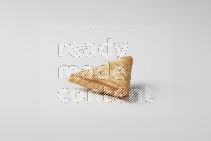 One fried sambosa on a white background