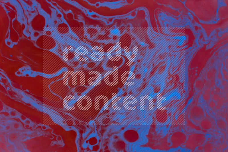 The image depicts a marbling effect with swirling patterns of red and blue