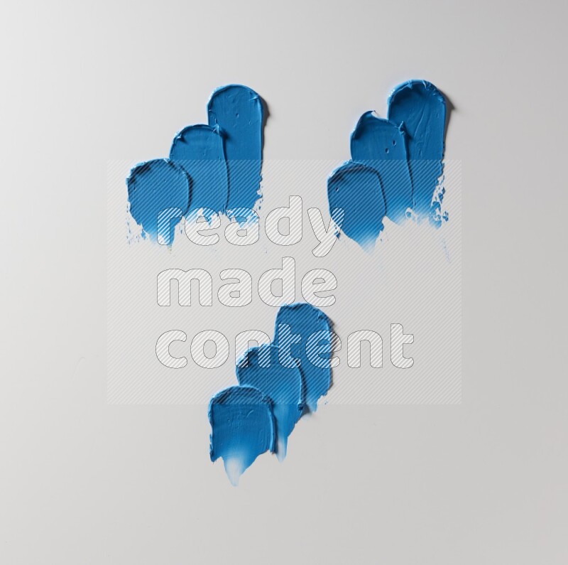 Blue painting knife strokes on white background
