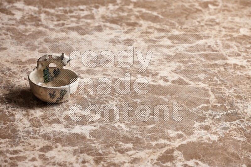 A pottery soap holder on beige marble background