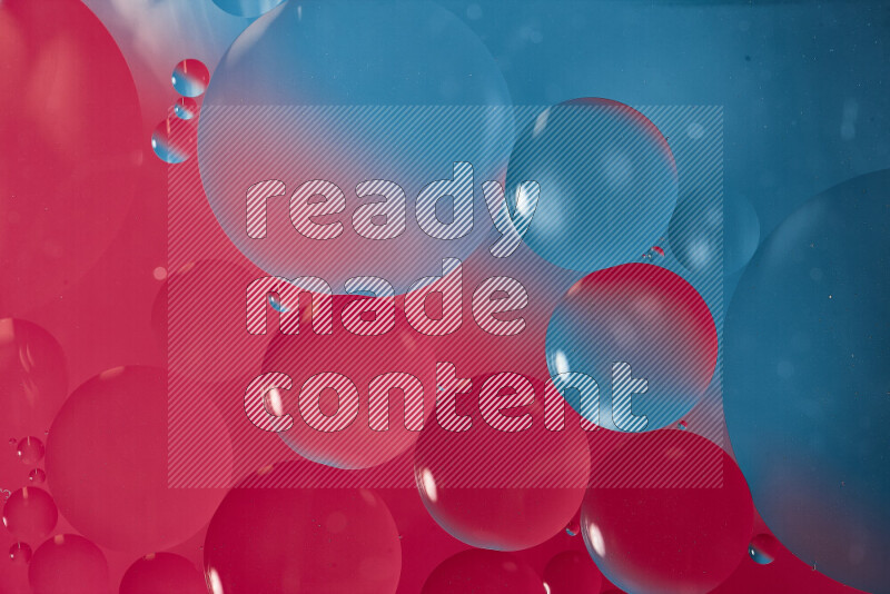 Close-ups of abstract oil bubbles on water surface in shades of blue and pink