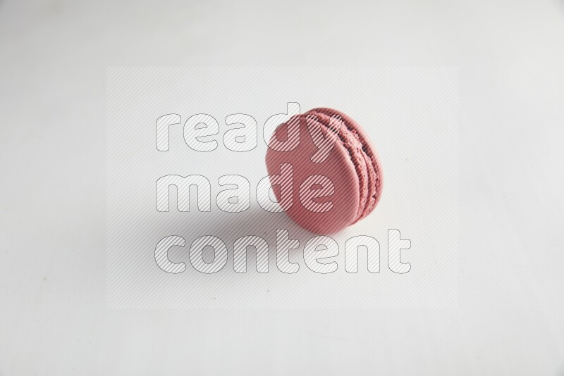 45º Shot of Pink Raspberry macaron on white background