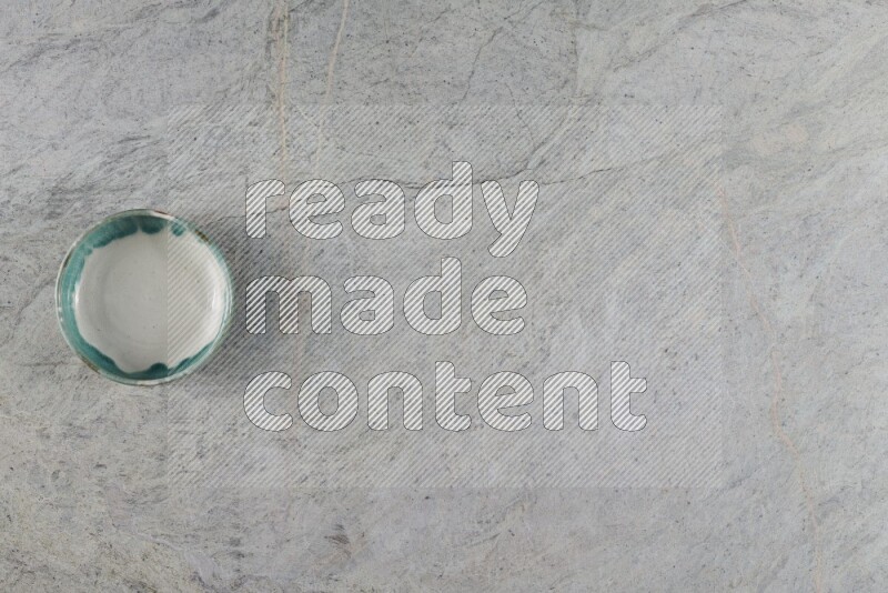 A multicolored pottery Bowl on grey marble background
