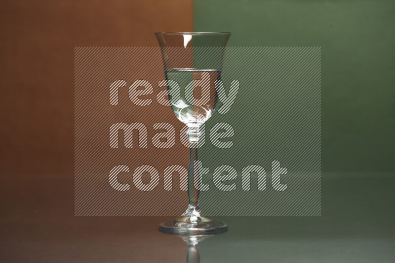 The image features a clear glassware filled with water, set against brown and dark green background