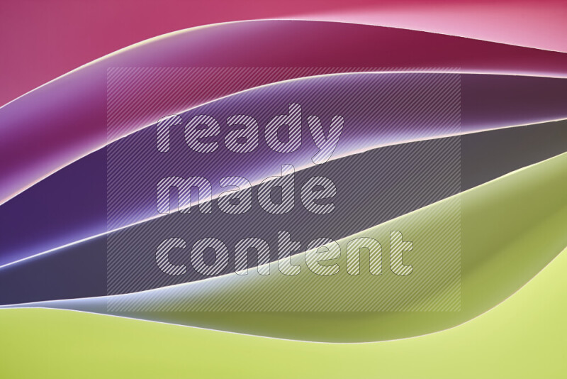 This image showcases an abstract paper art composition with paper curves in green and pink gradients created by colored light