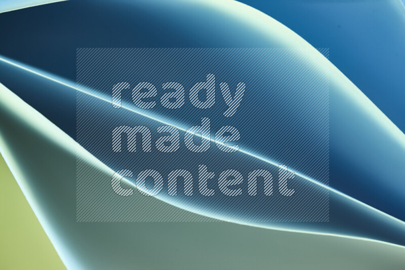 This image showcases an abstract paper art composition with paper curves in green and blue gradients created by colored light