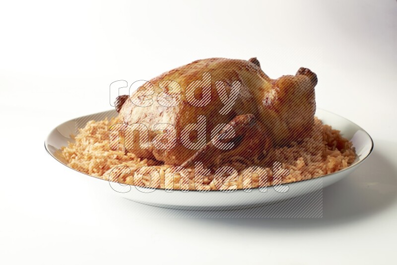 red basmati Rice with whole roasted chicken on a white plate with a silver rim direct on white background