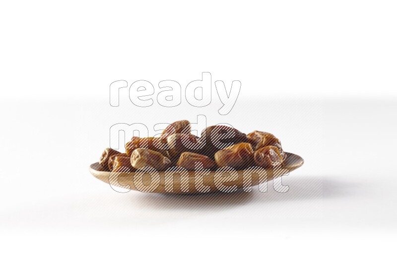Dates in a wooden plate on white background