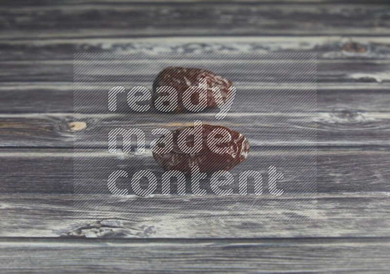 two madjoul dates on a wooden grey background