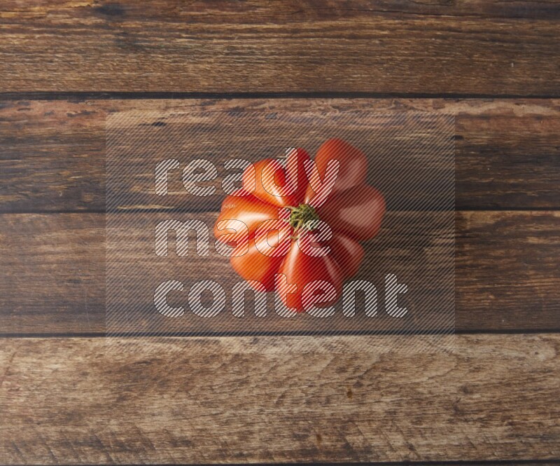 Single topview Heiloom Tomato on a wooden background