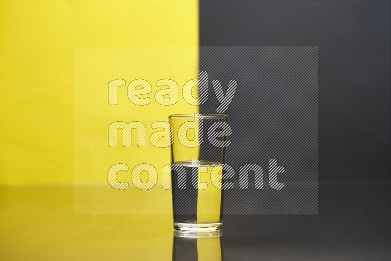 The image features a clear glassware filled with water, set against yellow and black background