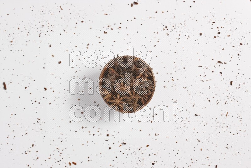 Star Anise in a wooden bowl on white flooring