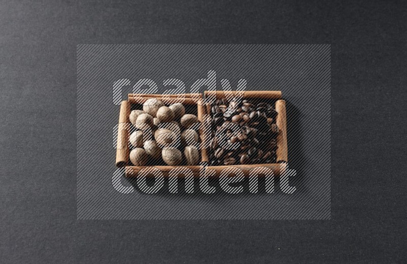 2 squares of cinnamon sticks full of coffee beans and nutmeg on black flooring