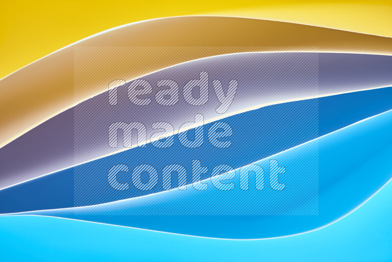 This image showcases an abstract paper art composition with paper curves in blue and yellow gradients created by colored light