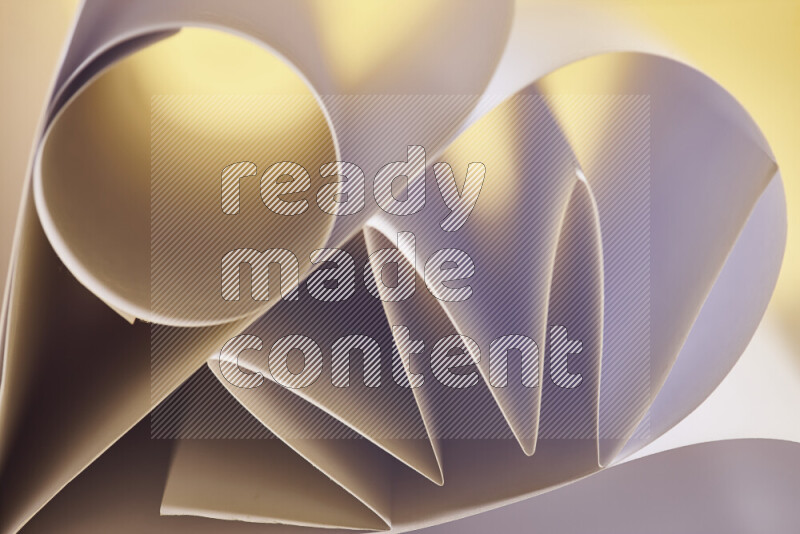 An artistic display of paper folds creating a harmonious blend of geometric shapes, highlighted by soft lighting in white and gold tones