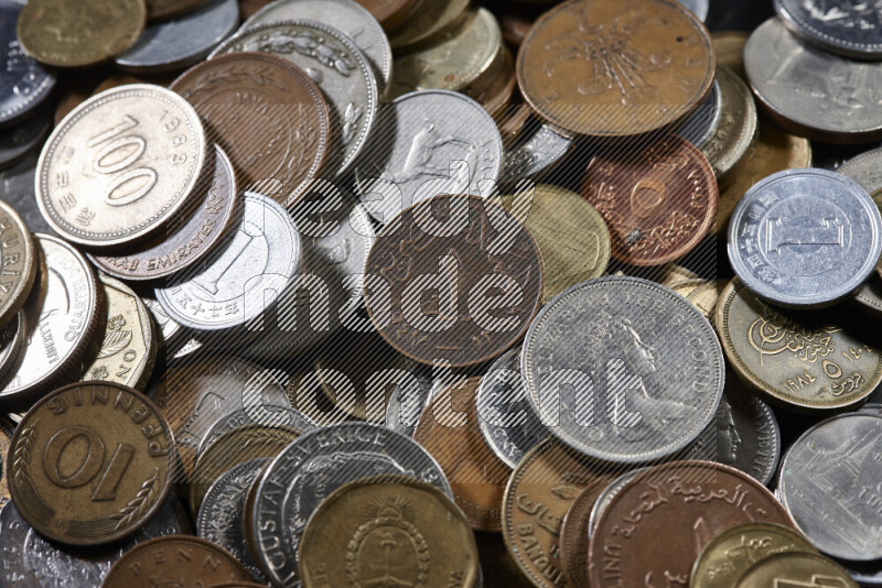 A close-ups of random old coins on black background