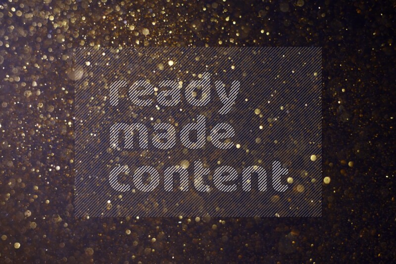 Gold glitter powder isolated on black background