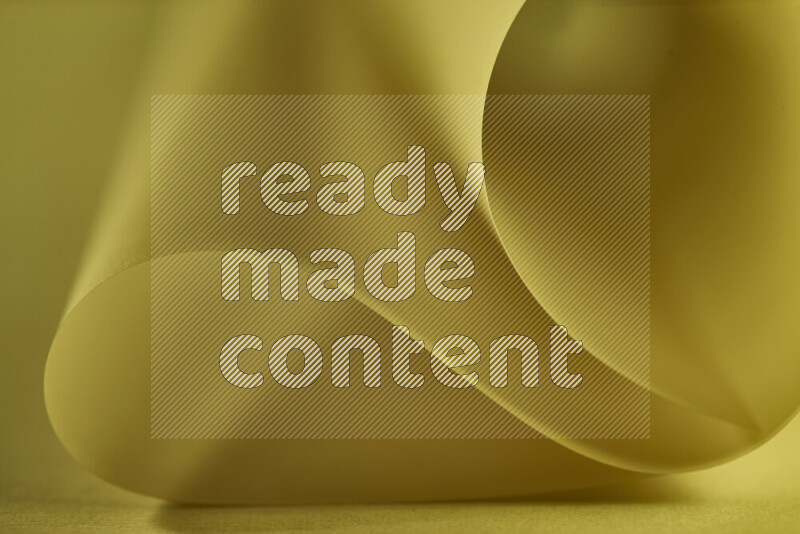 An abstract art piece displaying smooth curves in gold gradients created by colored light