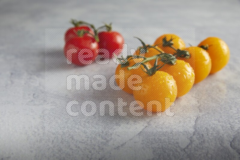 Mixed cherry tomato veins on a textured light grey background 45 degree