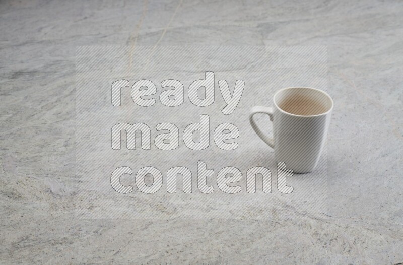 A white ceramic mug on grey marble background