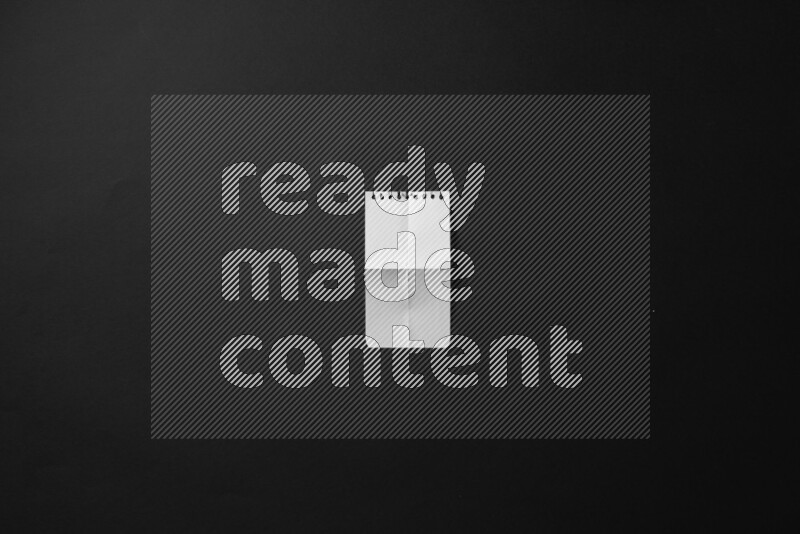 Folded notebook sheet on black background