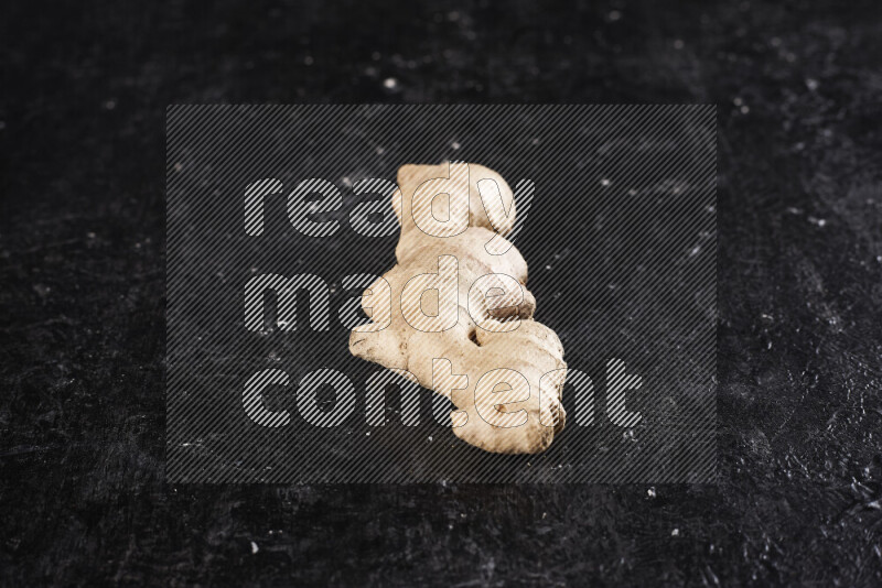 Fresh ginger root on black background