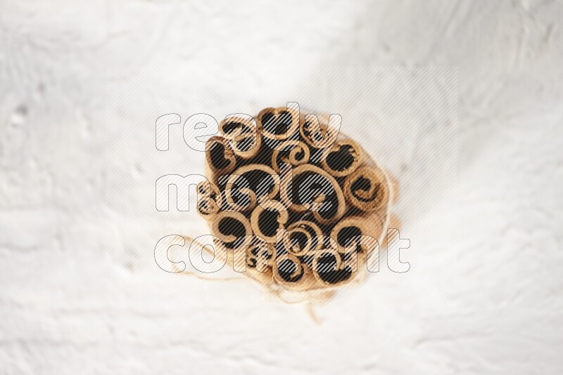 A bounded stack of cinnamon sticks on white background