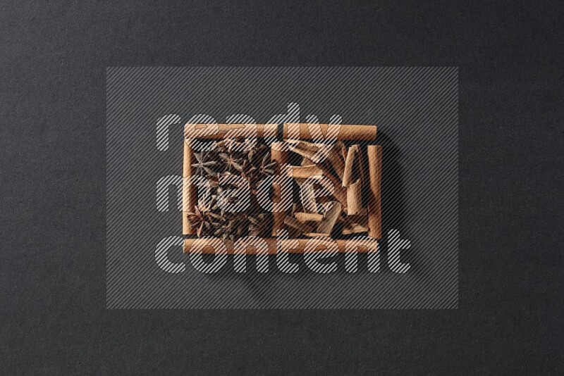2 squares of cinnamon sticks full of star anise and cinnamon on black flooring