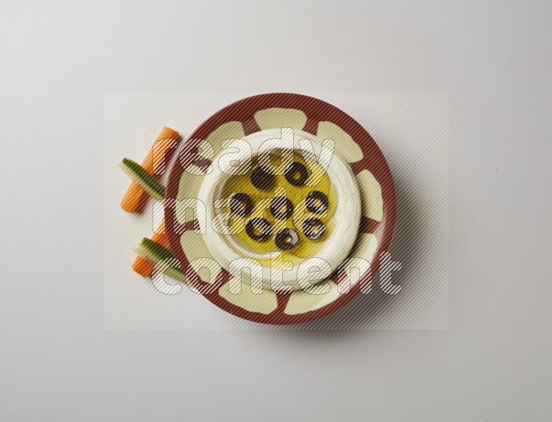 Lebnah garnished with sliced olives in a traditional plate on a white background