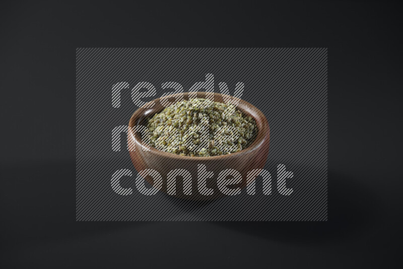 Freekeh in a wooden bowl on grey background