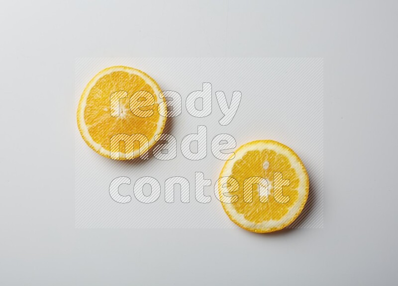 Two orange slices on white background