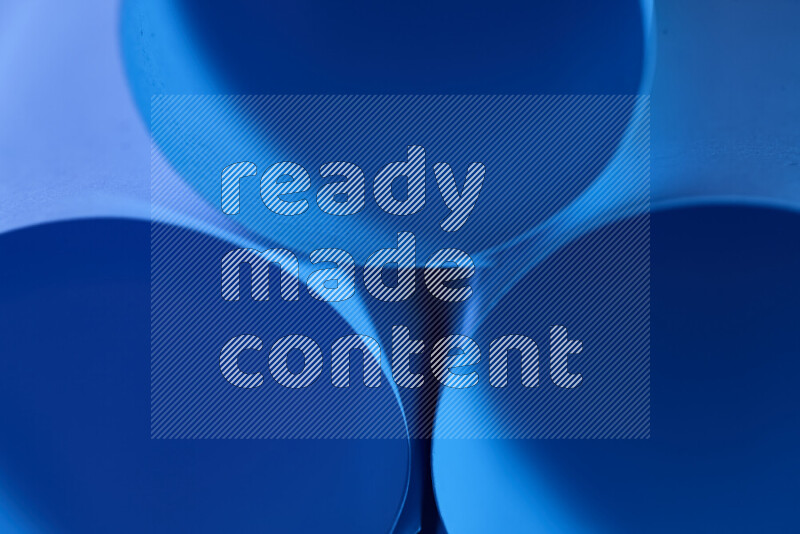 The image shows an abstract paper art with circular shapes in varying shades of blue