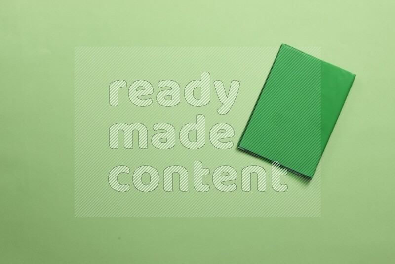 Multicolored notebooks on green background